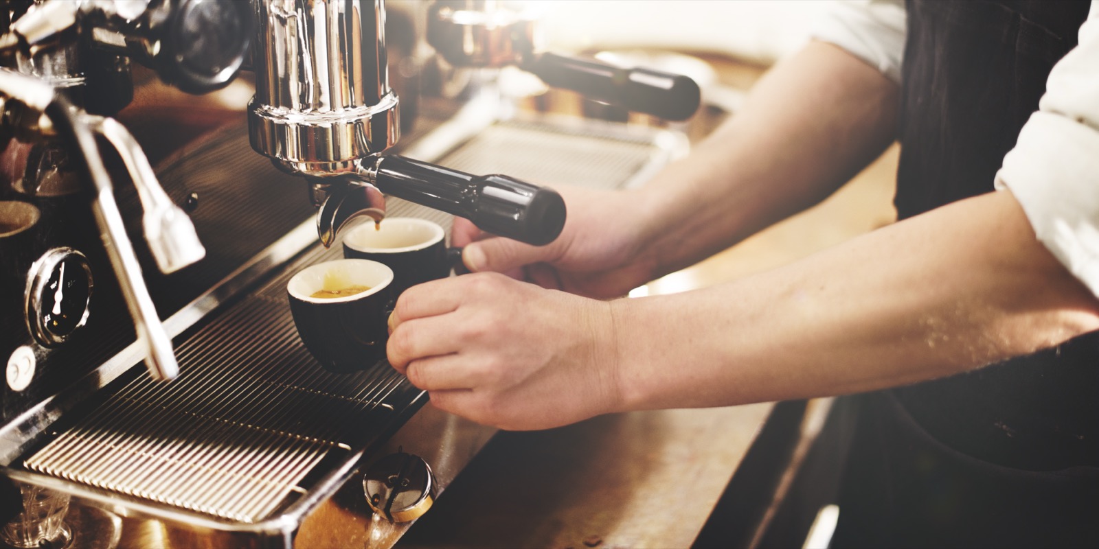 Barista pulling espresso on a commercial machine